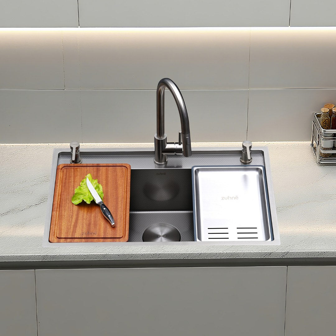Oslo workstation sink on a light kitchen counter with cutting board and colander in use