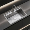 Oslo Honeycomb Natural workstation sink with pull-down faucet on a dark countertop
